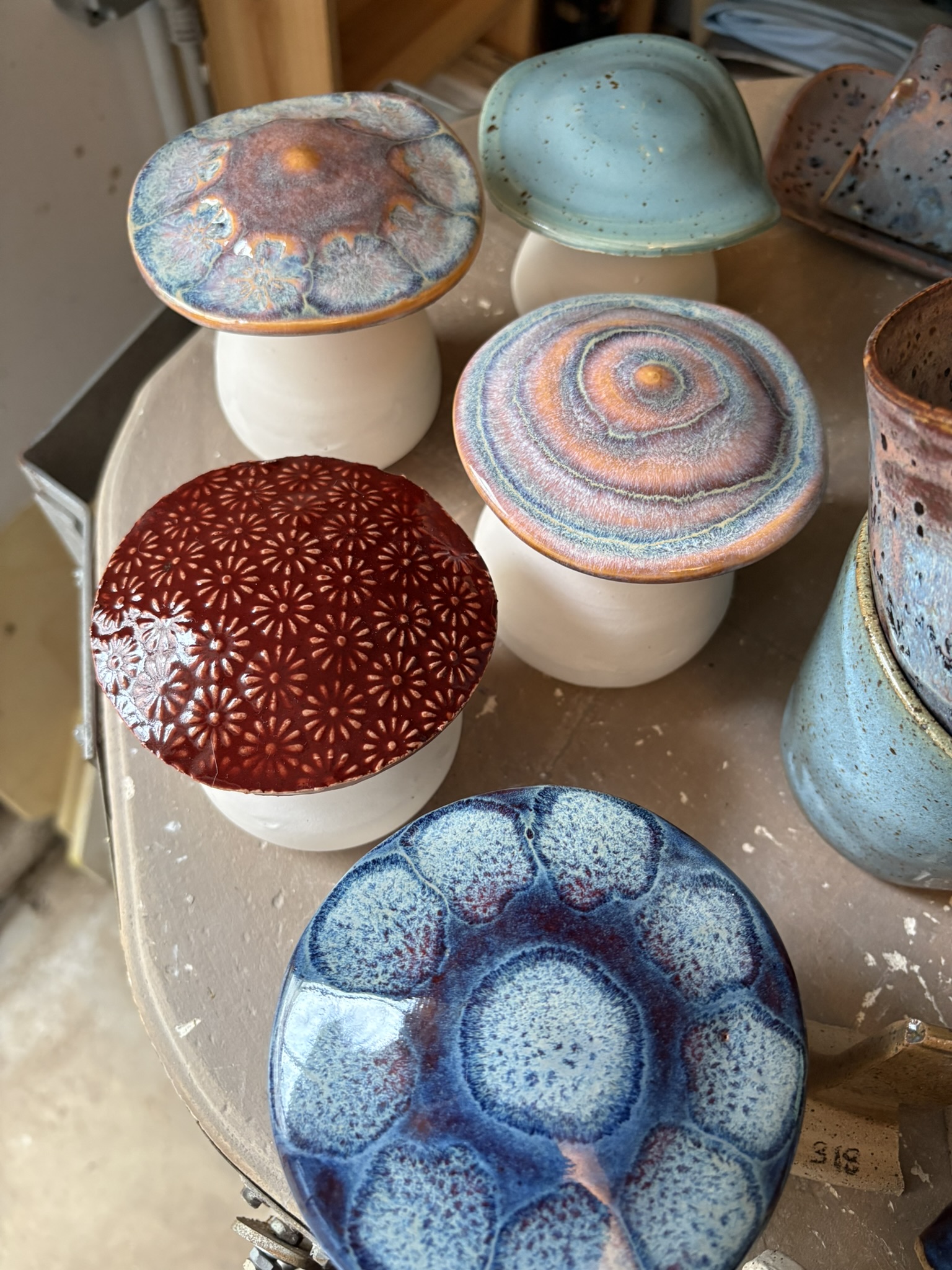 Handmade lidded jars with richly patterned glazes